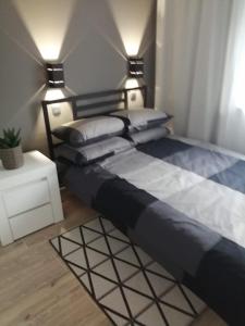 a bedroom with a bed with two pillows on it at Apartamenty u Nataszy in Ustrzyki Dolne