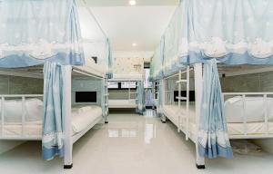 a hospital room with several bunk beds in it at ALOHA SAIGON HOSTEL by Local Travel Experts - Newly opened, Less-touristy location, Spacious rooms, Glass shower bathroom, Free breakfast, Quiet alley and Cultural exploration in Ho Chi Minh City