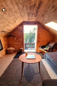 a living room with a couch and a table at Cozy Cabin Styled Loft in Kiruna