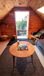a living room with a coffee table and a window at Cozy Cabin Styled Loft in Kiruna