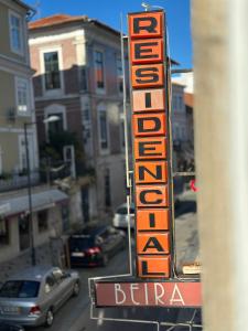 a sign for a restaurant on the side of a street at A Beira Hostel in Aveiro