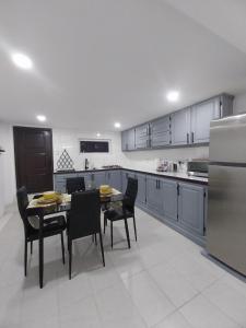 a kitchen with a table and chairs in it at Samm's Studio Apartment in Hyde Park