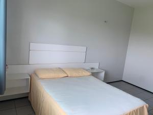 Ένα ή περισσότερα κρεβάτια σε δωμάτιο στο Pousada Alvorada
