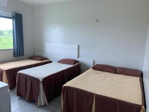 מיטה או מיטות בחדר ב-Pousada Alvorada