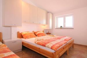 - une chambre avec un grand lit et des oreillers orange dans l'établissement Puccini, à Poreč