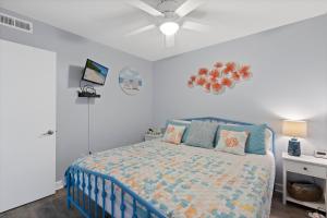 a bedroom with a bed and a ceiling fan at Beachfront, Updated, Topsail Dunes Shining Sea in North Topsail Beach