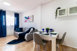 a living room with a table and a couch at Espanatour CINUELICA III in Orihuela Costa