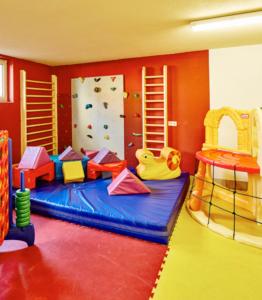 a childrens play room with a slide and a play set at Blockhütte Tirol in Ried im Oberinntal