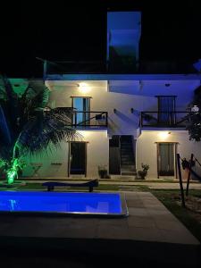 a house with a blue pool in front of it at night at Vila Kitemania in Prea +11 photos