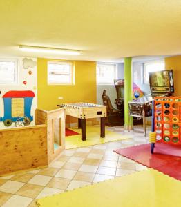 a room with a play room with a table at Apartment Alpenherz in Ried im Oberinntal