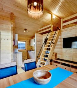 una habitación con una mesa y una escalera en una casa en Blockhütte Bergzauber, en Ried im Oberinntal