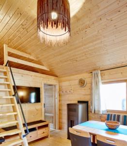 a dining room with a table and a chandelier at Blockhütte Bergzauber in Ried im Oberinntal