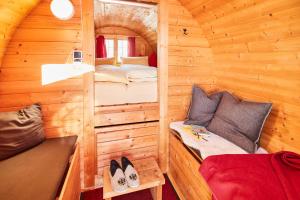 Cabaña pequeña con cama y banco. en Wohnfass links, en Ried im Oberinntal