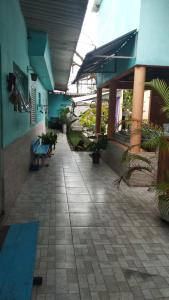 a hallway of a building with benches and plants at Equilibra Soul in Caraguatatuba