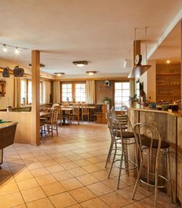 a kitchen and dining room with tables and chairs at Blockhütte Bergzauber in Ried im Oberinntal