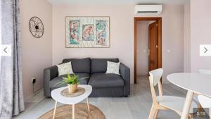 a living room with a couch and a table at Luis Braille Apt in Málaga