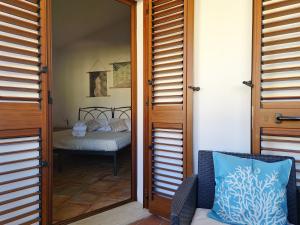 A bed or beds in a room at Le Melodie - Appartamenti con spazi esterni privati a Sos Alinos