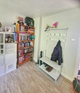 a small room with a book shelf and a book shelf at Two Bedroom Apartment in South Somerset in Wincanton