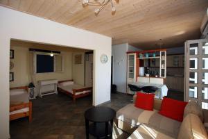 a living room with a couch and a bedroom at Anna's Home in Batsi