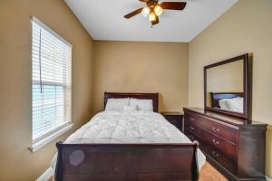 a bedroom with a bed with a dresser and a mirror at 30A Getaway Too! in Santa Rosa Beach