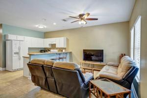 a living room with two couches and a kitchen at 30A Getaway Too! in Santa Rosa Beach