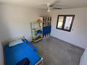 a bedroom with a blue bed in a room at Casa Azul - Pedasi in Pedasí Town