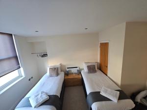 um quarto com duas camas e uma janela em Modern 2 bedrooms apartment in Town Centre 10 em Ipswich