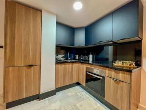 a kitchen with wooden cabinets and a stove top oven at Studio Haven in the Old Medina in Casablanca