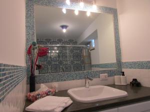 a bathroom with a sink and a mirror at Piazzetta Sweet Home in Capri