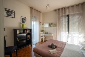 a bedroom with a bed and a chair and a desk at Guest House Ca' Lou al Teatro in Vicenza