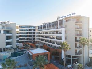 an aerial view of a hotel with palm trees at Aquila Porto Rethymno in Rethymno Town