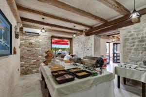 a kitchen with a table with food on it at Hotel Timun in Gdinj