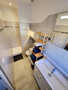 a small bathroom with a sink and a toilet at [LE REPOS] Maison 6 couchages avec jardin privé in Loubajas