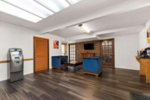 a living room with two blue chairs and a table at Rodeway Inn in Brooklawn