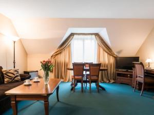 sala de estar con sofá y mesa con sillas en Hotel Wersal en Zakopane