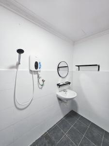 a white bathroom with a shower and a sink at Luna Hotel by Moonknight in George Town