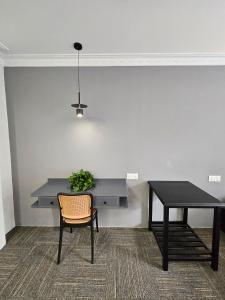 a desk and a table with a chair and a table at Luna Hotel by Moonknight in George Town