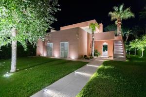 a home at night with lights on the lawn at Residence Corallo Portorosa Furnari in Furnari