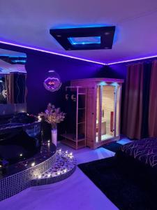 a purple room with a fish tank and a bed at LoveRoom by Sunnyroom in Perpignan