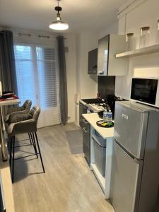 a kitchen with a refrigerator and a counter top at LA LOVEROOM by Sunnyroom in Perpignan