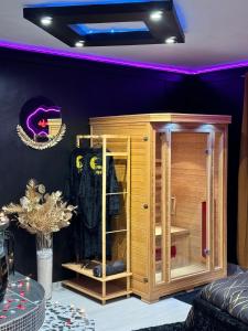 a wooden cabinet in a room with a table at LA LOVEROOM by Sunnyroom in Perpignan