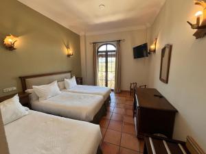 Posteľ alebo postele v izbe v ubytovaní Hotel Sierra de Ubrique