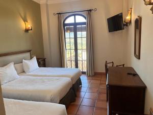 Posteľ alebo postele v izbe v ubytovaní Hotel Sierra de Ubrique