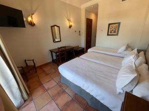 Posteľ alebo postele v izbe v ubytovaní Hotel Sierra de Ubrique