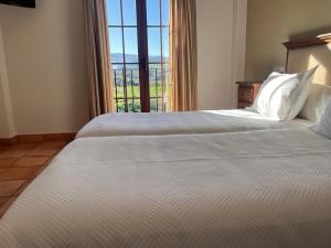 Posteľ alebo postele v izbe v ubytovaní Hotel Sierra de Ubrique
