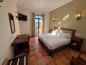 Posteľ alebo postele v izbe v ubytovaní Hotel Sierra de Ubrique