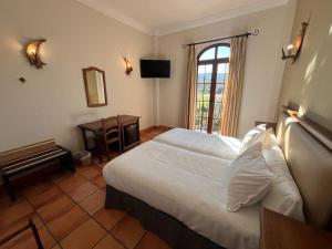 Posteľ alebo postele v izbe v ubytovaní Hotel Sierra de Ubrique
