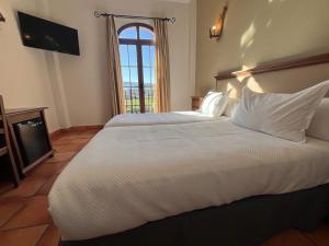 Posteľ alebo postele v izbe v ubytovaní Hotel Sierra de Ubrique