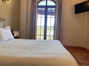 Posteľ alebo postele v izbe v ubytovaní Hotel Sierra de Ubrique