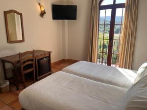Posteľ alebo postele v izbe v ubytovaní Hotel Sierra de Ubrique